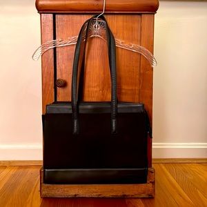 Black TUMI shoulder bag with leather trim. This bag is 13”W x 10”H.